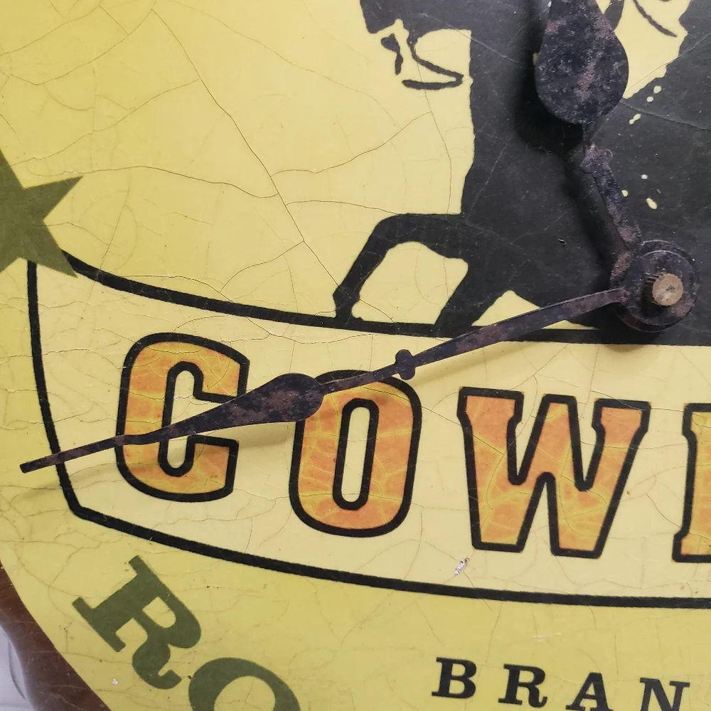 Metal Cowboy clock shaped like bottle cap. 191